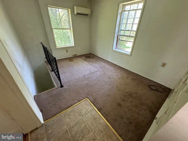 empty room with carpet and a wall unit AC