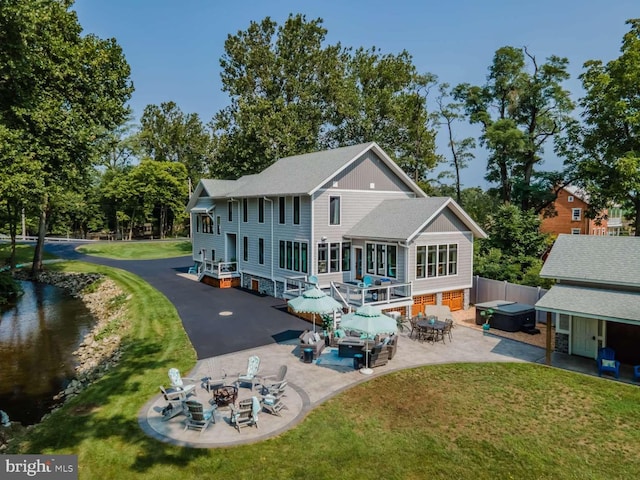 rear view of house featuring a patio area and a yard