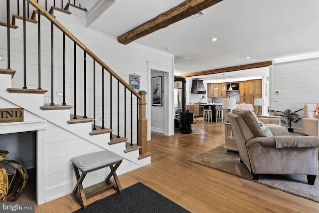 living room with beamed ceiling and hardwood / wood-style floors