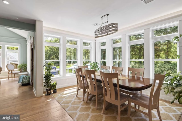 sunroom featuring an inviting chandelier