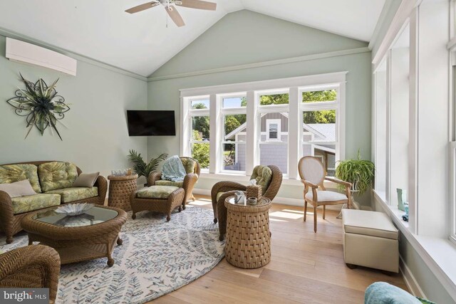 sunroom with ceiling fan, an AC wall unit, and lofted ceiling