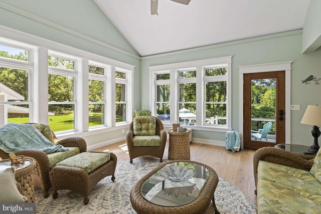 sunroom / solarium featuring ceiling fan, plenty of natural light, and lofted ceiling