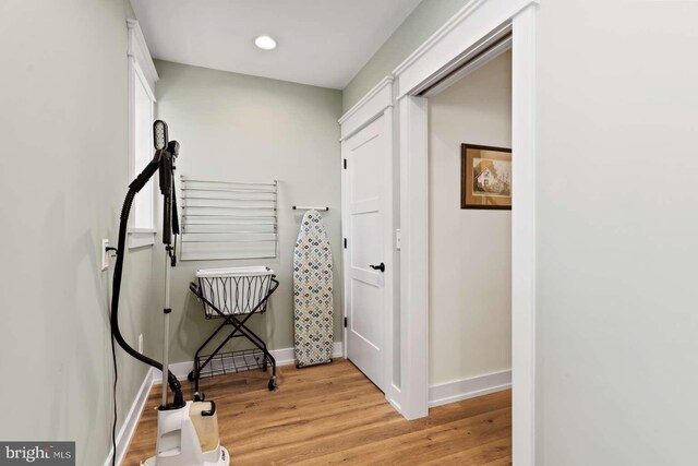 corridor with light hardwood / wood-style floors