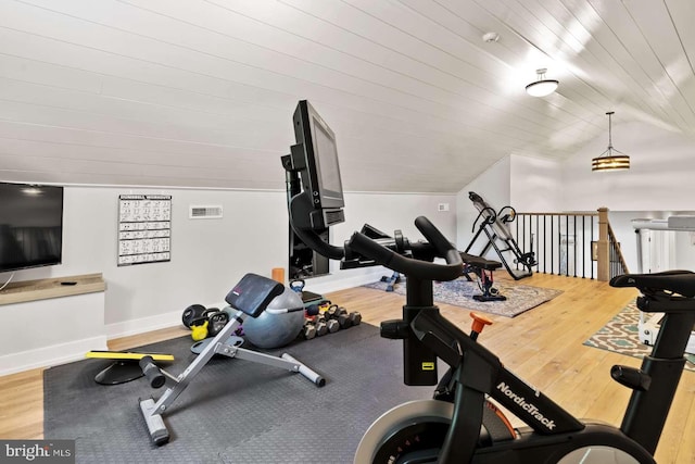 workout area with hardwood / wood-style flooring and lofted ceiling