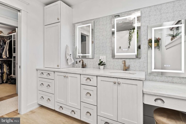 bathroom featuring backsplash, hardwood / wood-style floors, and vanity