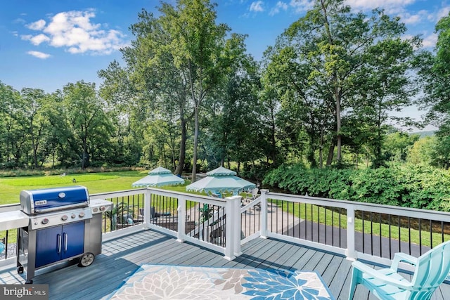 wooden deck with a lawn