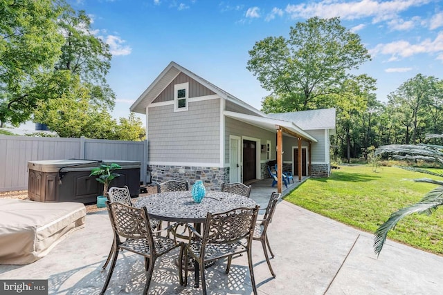 view of patio / terrace with a hot tub