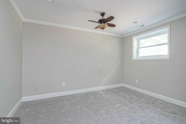 spare room featuring ceiling fan, carpet flooring, and crown molding