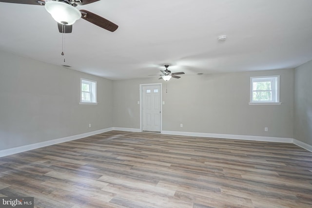 unfurnished room featuring hardwood / wood-style flooring and ceiling fan