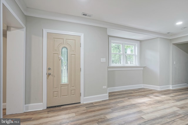 entrance foyer featuring light hardwood / wood-style flooring and ornamental molding