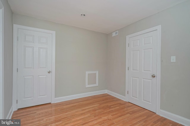 spare room with light hardwood / wood-style flooring