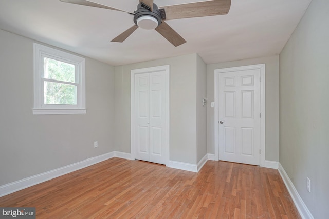 unfurnished bedroom with ceiling fan and light wood-type flooring