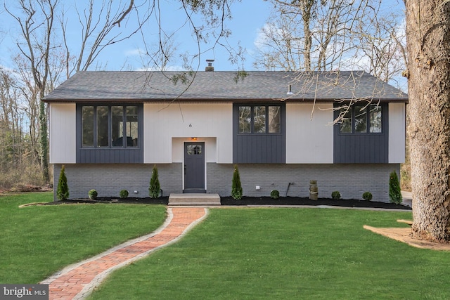 raised ranch with a front yard