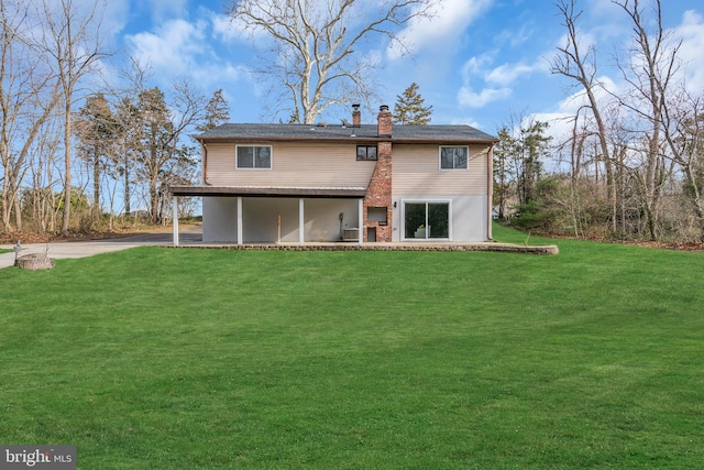 rear view of house with a yard