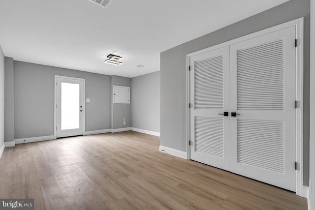 unfurnished bedroom with light wood-type flooring