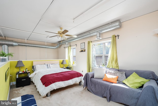 bedroom featuring a ceiling fan and light colored carpet