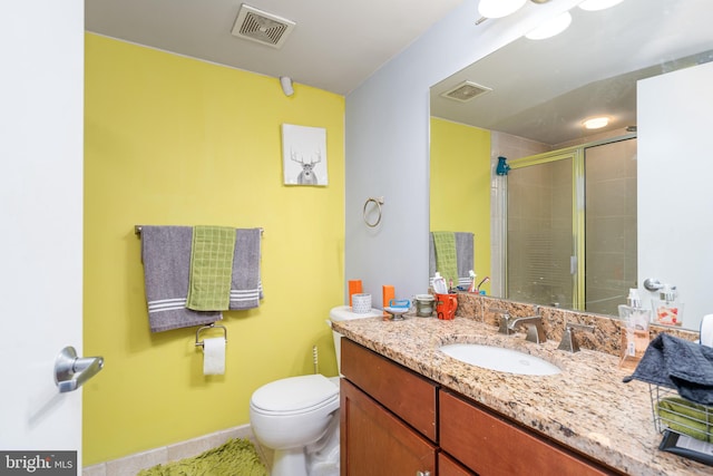 bathroom featuring visible vents, a shower stall, toilet, and vanity