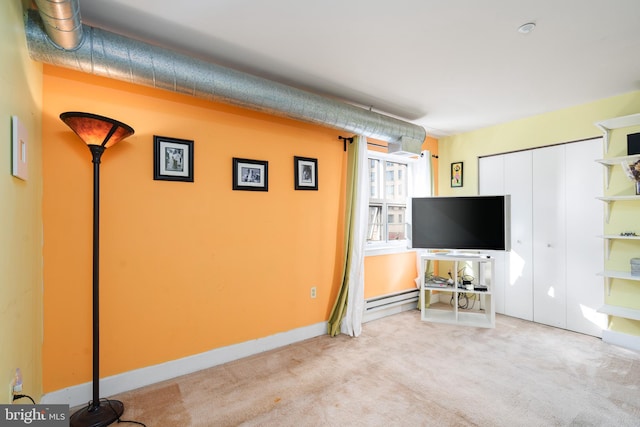 unfurnished living room with light carpet, a baseboard radiator, and baseboards