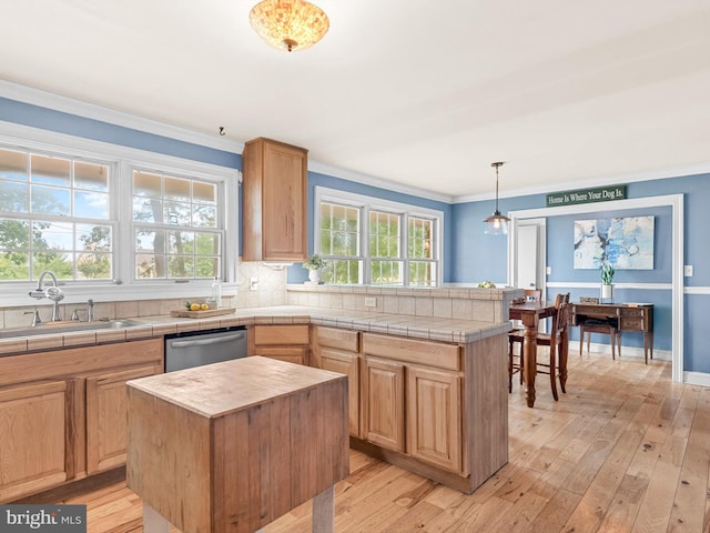 kitchen with plenty of natural light, dishwasher, and a center island