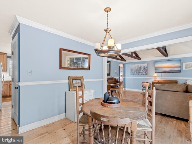 dining space featuring ornamental molding, beamed ceiling, light hardwood / wood-style flooring, and a chandelier