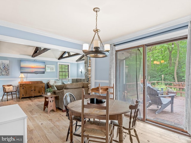 dining room featuring a notable chandelier, light hardwood / wood-style floors, and beamed ceiling