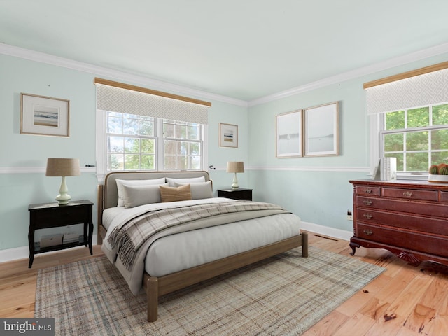 bedroom with light hardwood / wood-style flooring and ornamental molding