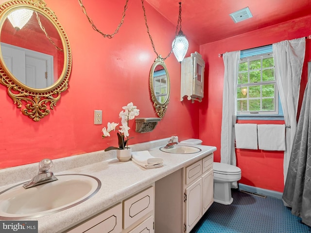 bathroom featuring vanity, toilet, and tile patterned floors