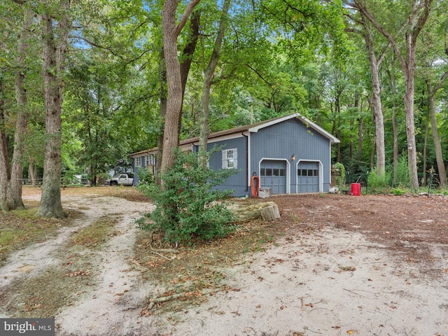 view of front of property featuring an outdoor structure and a garage