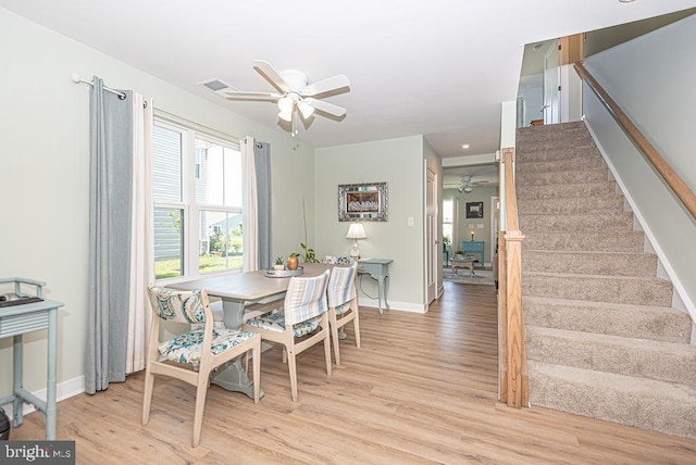 dining area featuring ceiling fan and light wood-type flooring