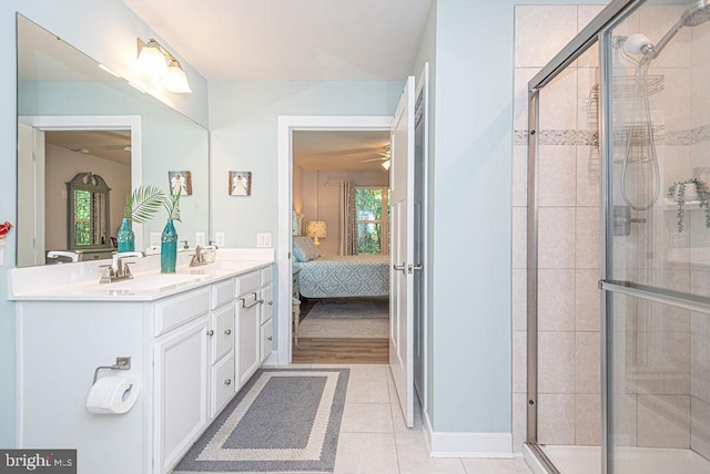 bathroom featuring vanity, ceiling fan, an enclosed shower, and tile patterned floors