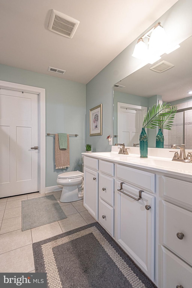 bathroom with tile patterned floors, toilet, and vanity