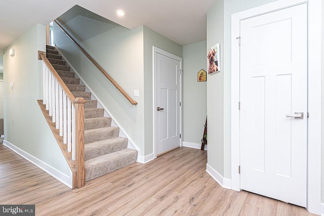 stairs featuring hardwood / wood-style floors