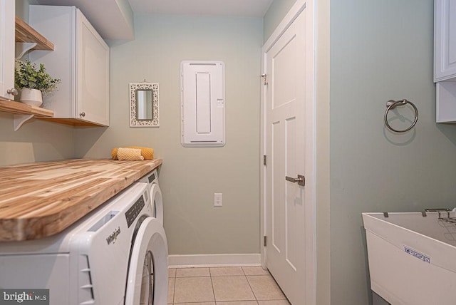 laundry room with independent washer and dryer, cabinets, light tile patterned floors, and electric panel