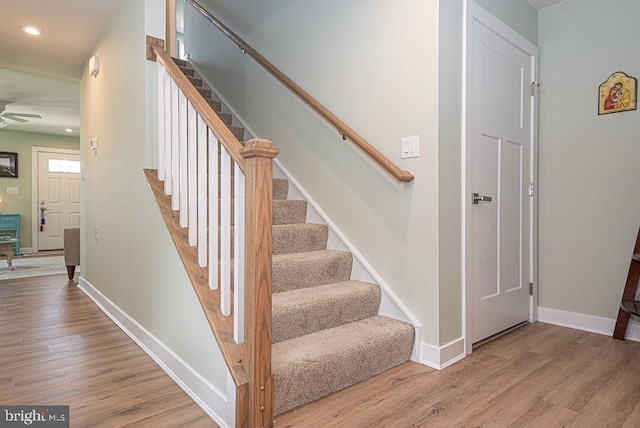 staircase with wood-type flooring