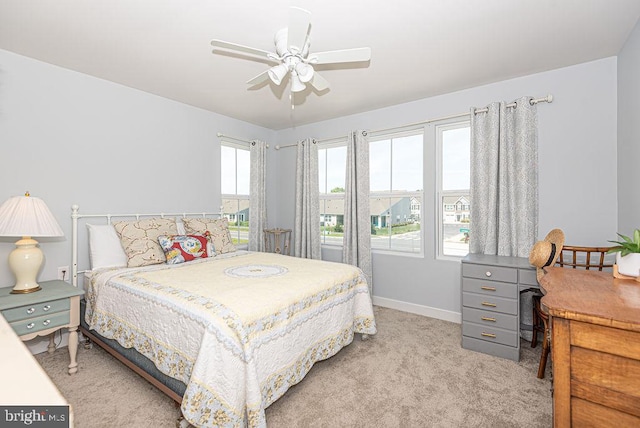 bedroom with light colored carpet and ceiling fan