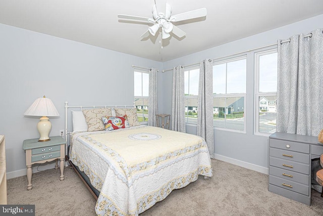 bedroom featuring light colored carpet and ceiling fan