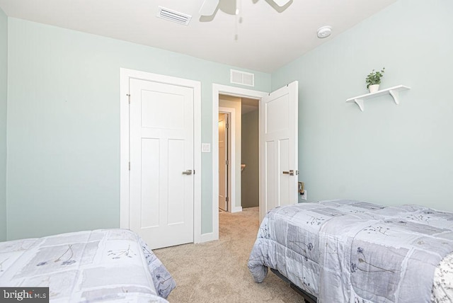 bedroom featuring ceiling fan and light carpet