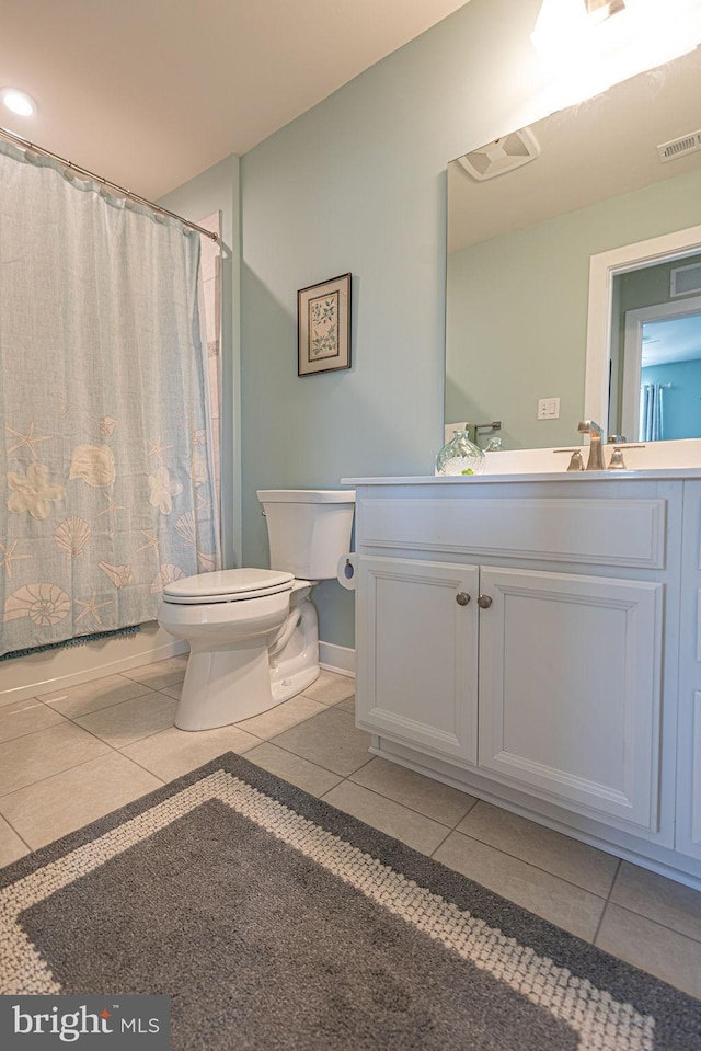 bathroom with tile patterned floors, toilet, and vanity