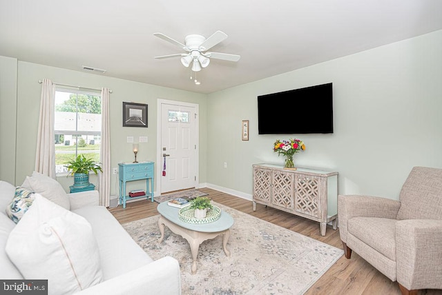 living room featuring ceiling fan and light hardwood / wood-style floors