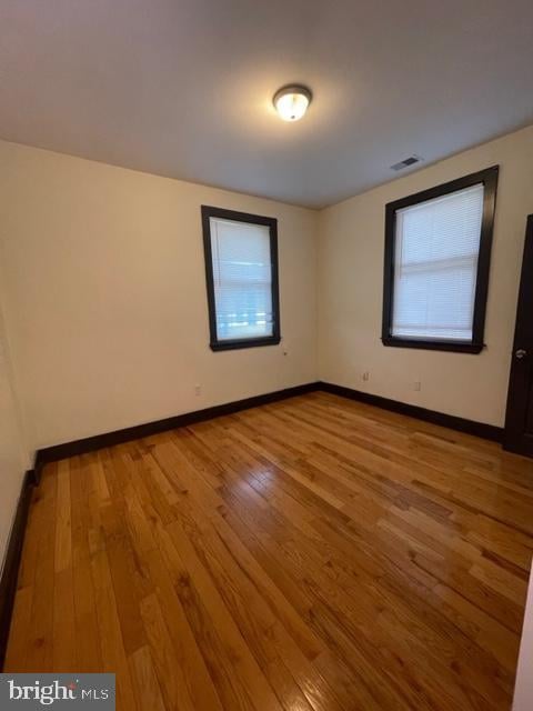 spare room with hardwood / wood-style floors