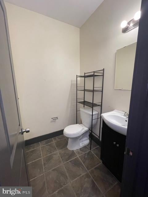 bathroom featuring tile patterned floors, toilet, and vanity