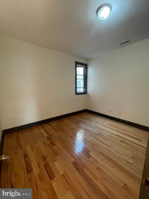 empty room featuring hardwood / wood-style flooring