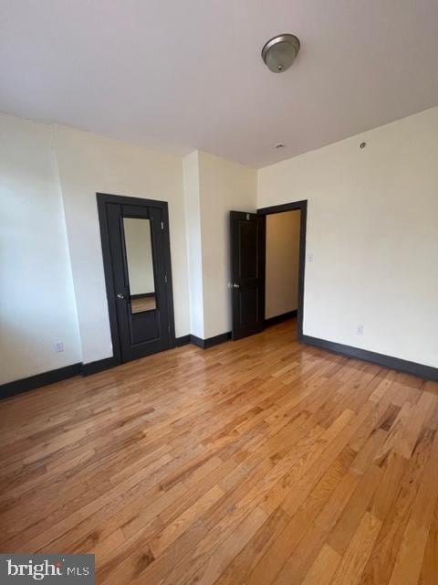 unfurnished bedroom with light wood-type flooring