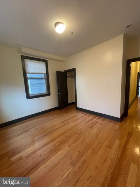 unfurnished room featuring hardwood / wood-style flooring