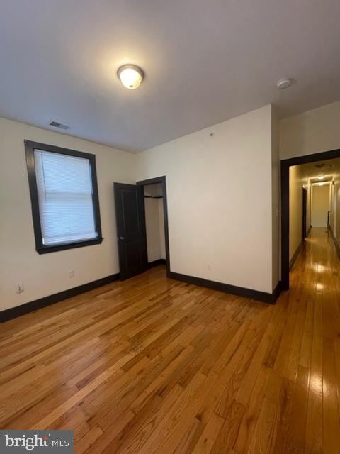 empty room with hardwood / wood-style flooring