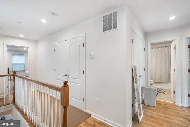 hallway with light hardwood / wood-style flooring