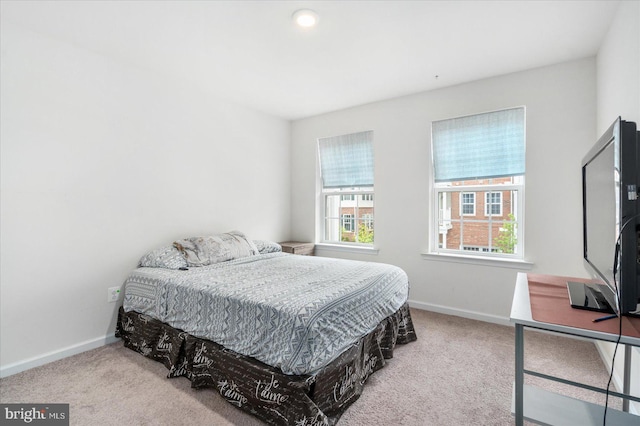 bedroom featuring light carpet