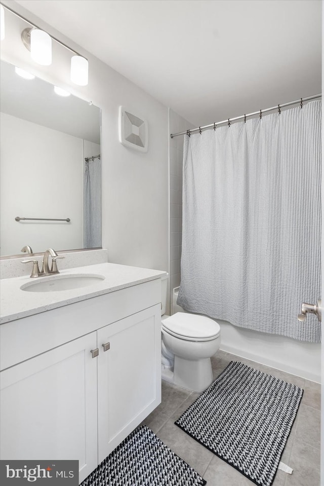 full bathroom featuring tile patterned floors, vanity, shower / tub combo, and toilet