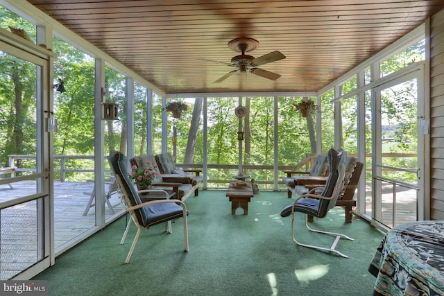 sunroom featuring wooden ceiling, ceiling fan, and a wealth of natural light