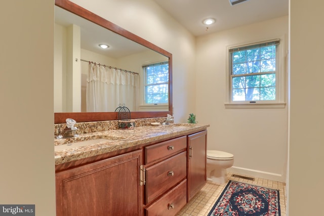 full bathroom with a healthy amount of sunlight, visible vents, and a sink